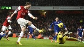 Late goals from Bendtner and Walcott keep Arsenal on top of the pile